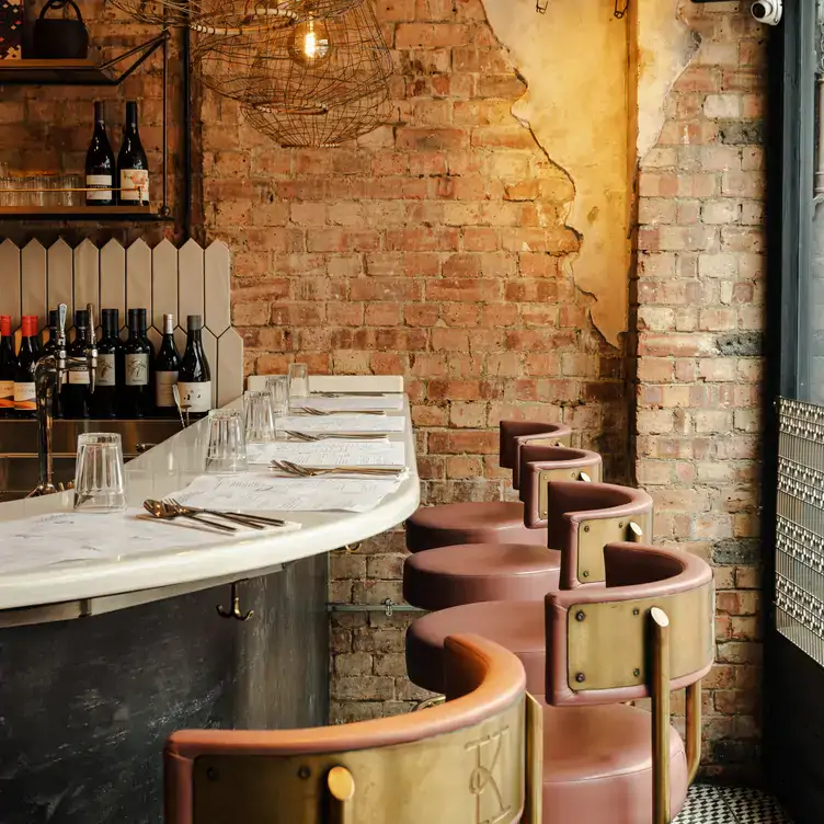 The bar area of Kricket, one of the best Indian restaurants in Soho, with exposed brick walls.