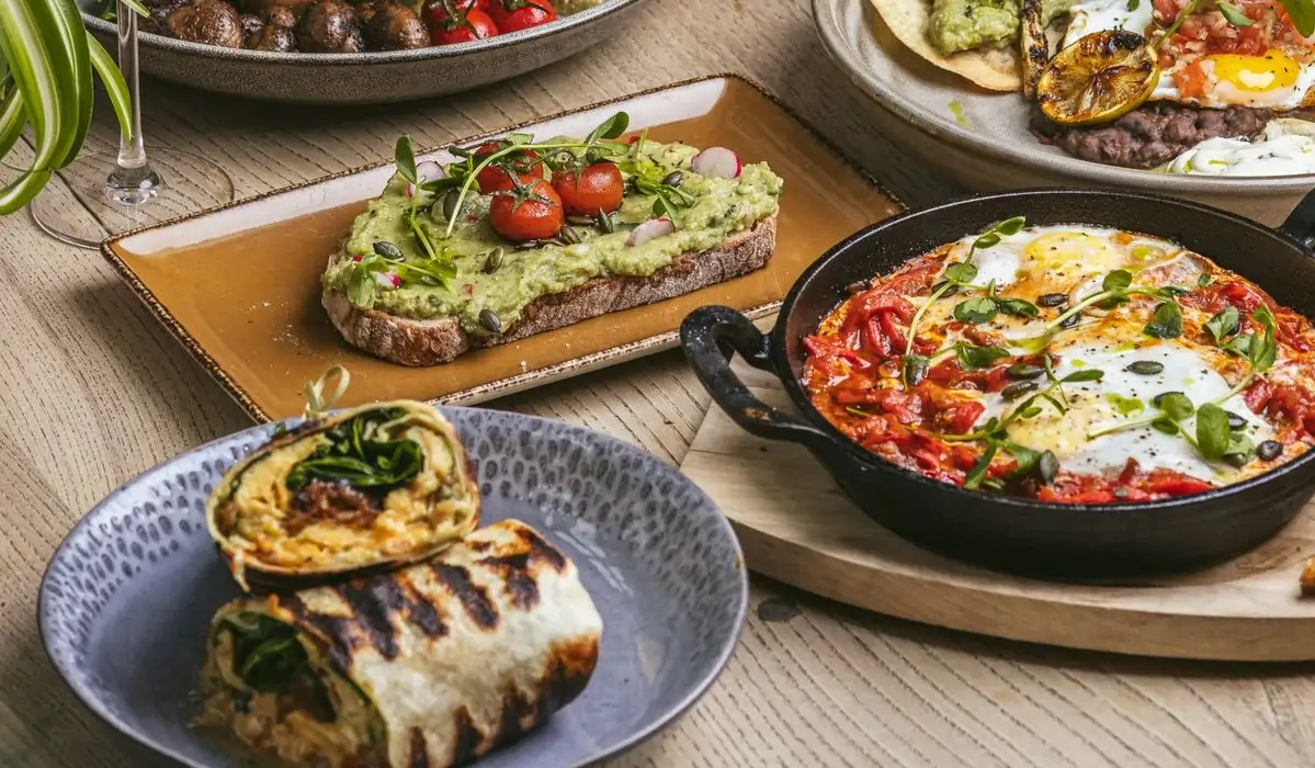 several breakfast plates including shakshuka and a breakfast burrito at London restaurant Archie's