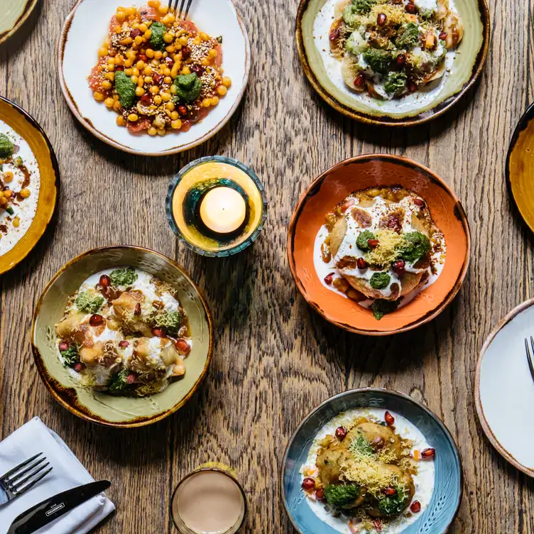 A spread of Indian dishes sit on a table at Cinnamon Bazaar - Covent Garden in London