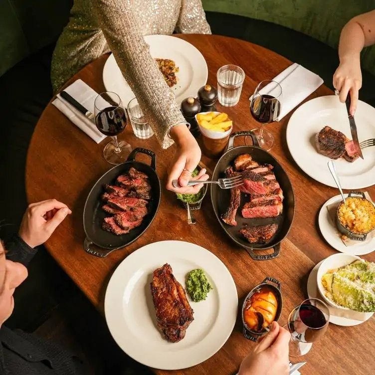 Diners tucking into steak plates at Hawksmoor Edinburgh