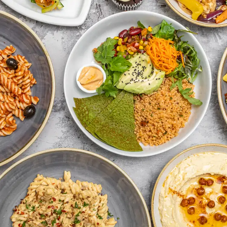 A fresh plant-based plate with couscous, avocado, salad, and crispy crackers at The Veg Box café - one of the best vegan restaurants in London.