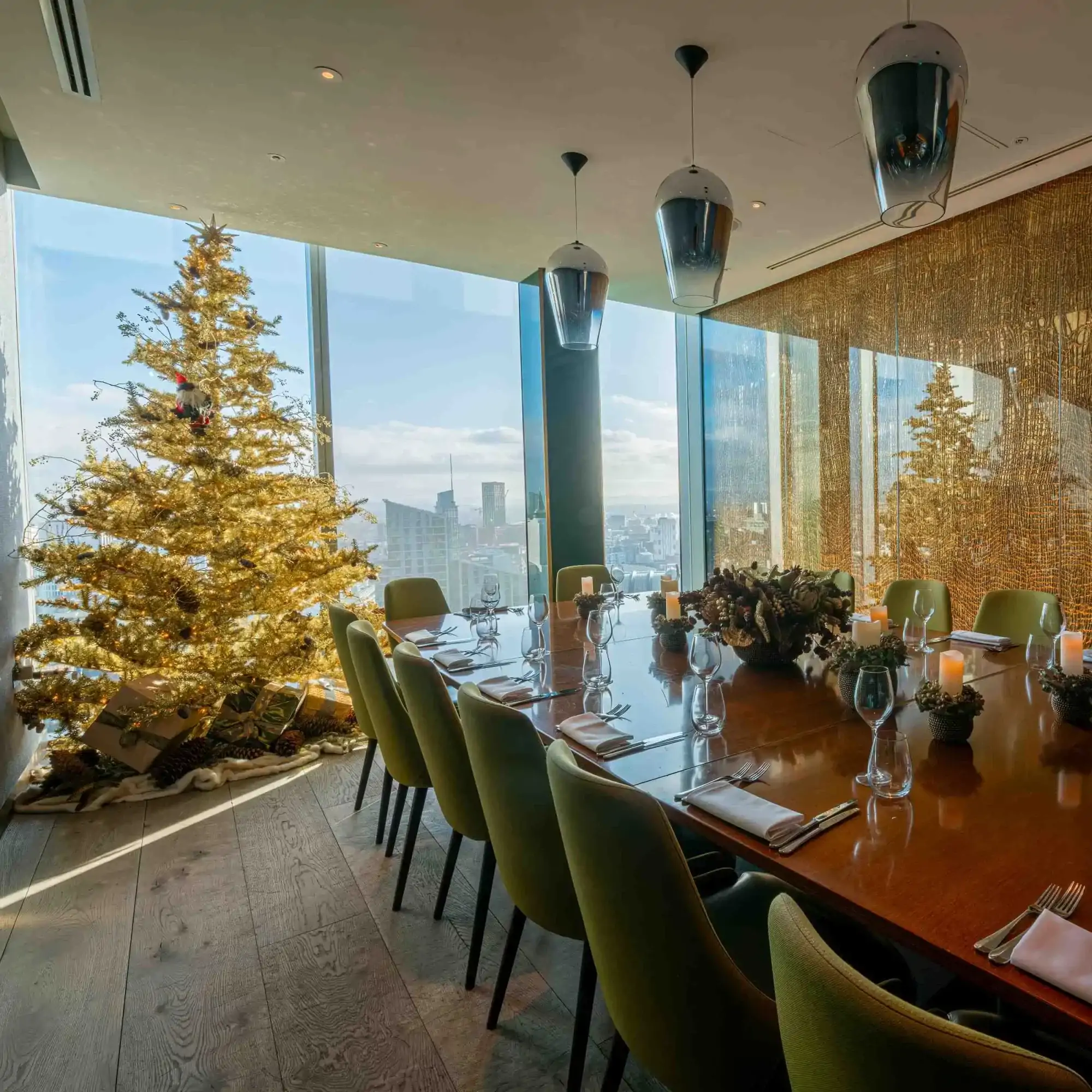 A night-time shot of the interior of one of the most festive restaurants in the UK, 20 Stories Restaurant, with a view of the sunset out of the window.