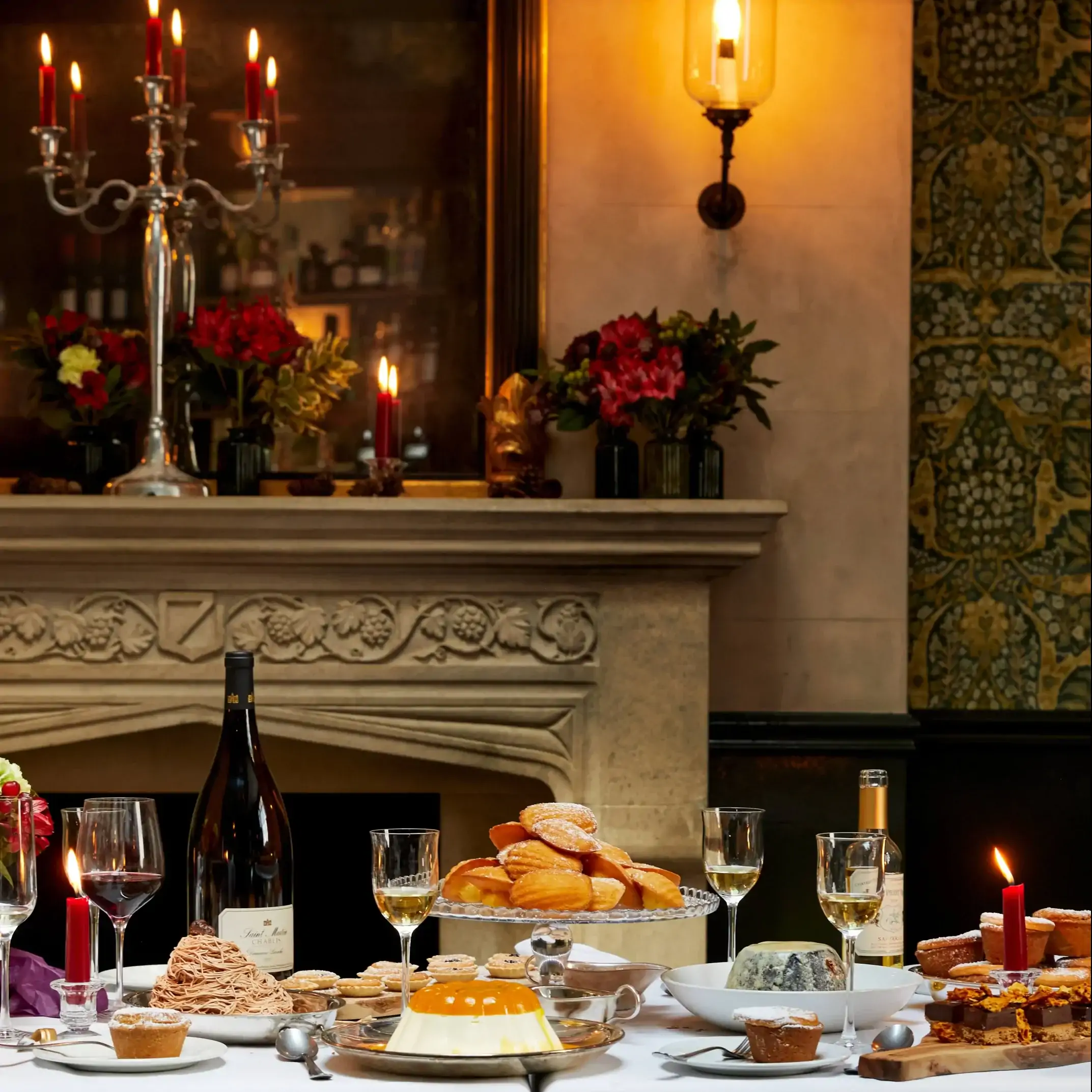 A long table by the fireplace at The Thomas Cubitt Pub Belgravia, one of the most festive restaurants in the UK, set with turkey and all the trimmings.