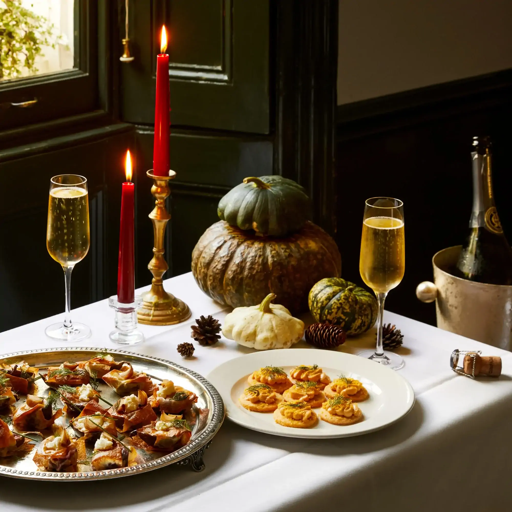 A plate of canapes with champagne from the festive menu at The Thomas Cubitt Pub Belgravia, one of the best Christmas dinner restaurants in the UK.