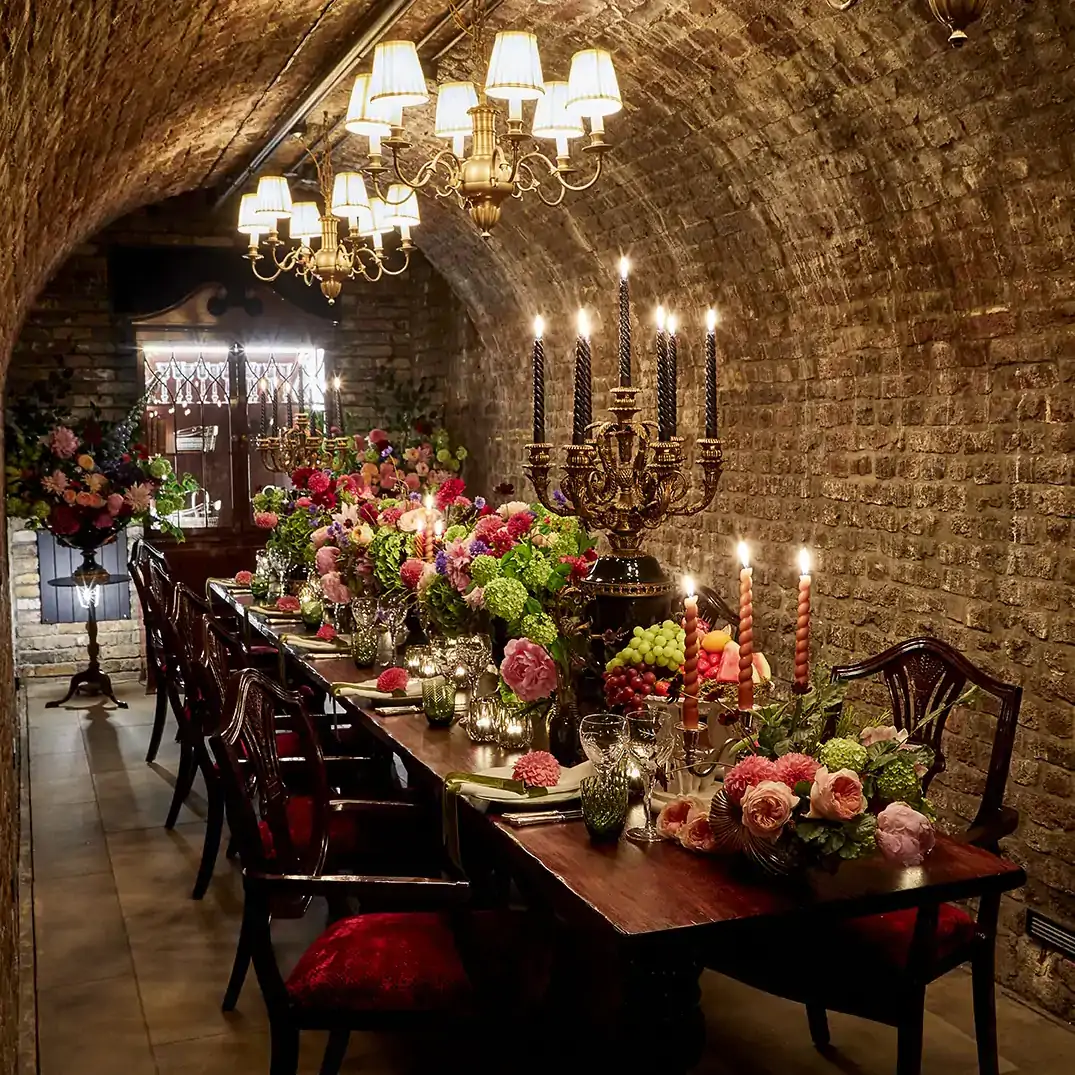 A private dining room at The Lanesborough, one of the best restaurants for Christmas dinner, with a rounded tunnel-style ceiling and Christmas decorations on the table.