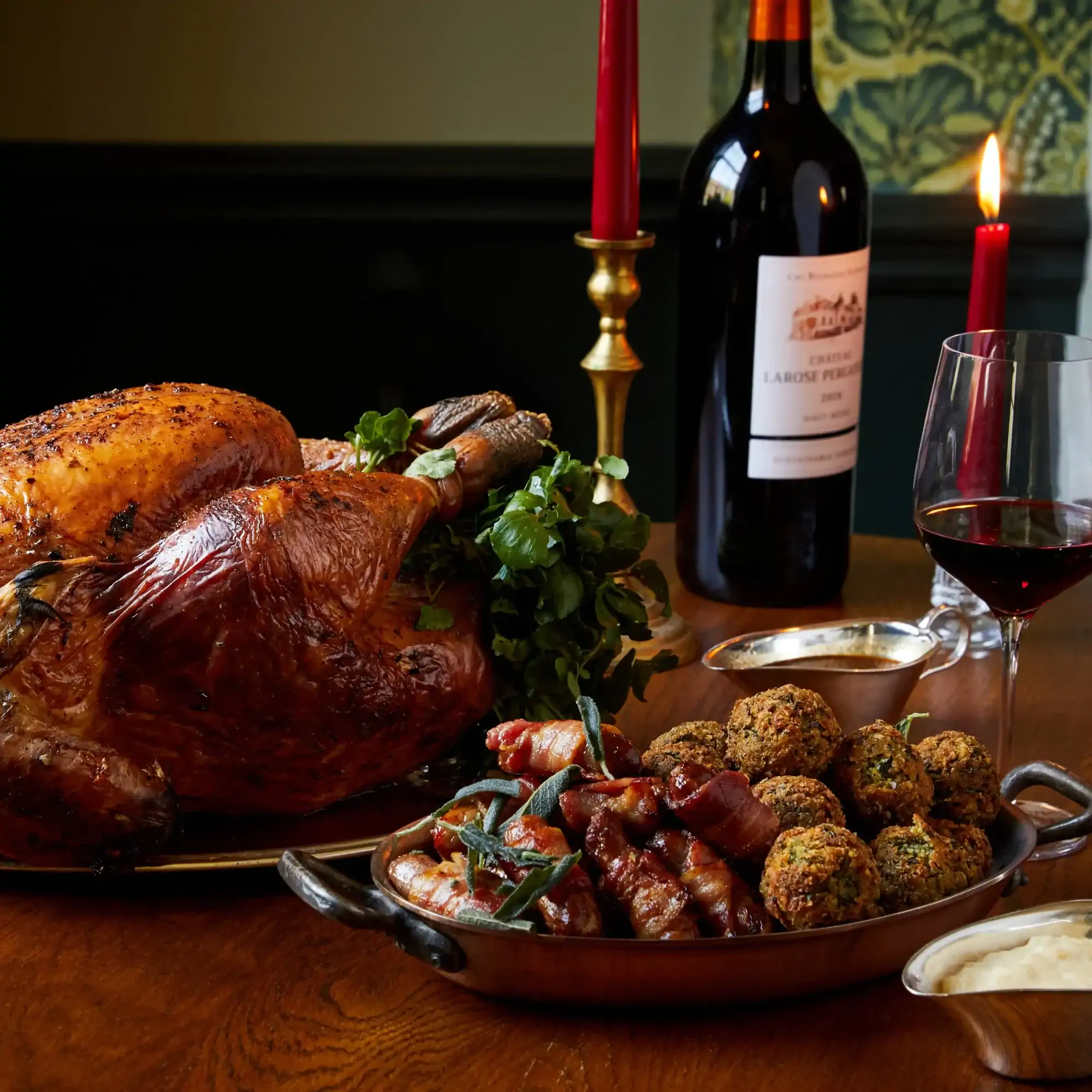 A whole cooked turkey with stuffing and pigs in blankets on a table at The Thomas Cubitt Pub Belgravia, one of the best Christmas restaurants in London.