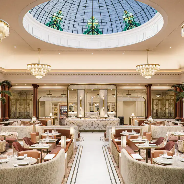 A bar and dining area at Savoy Lounge at The Savoy, one of the best restaurants for Christmas, with cream and bronze decor.