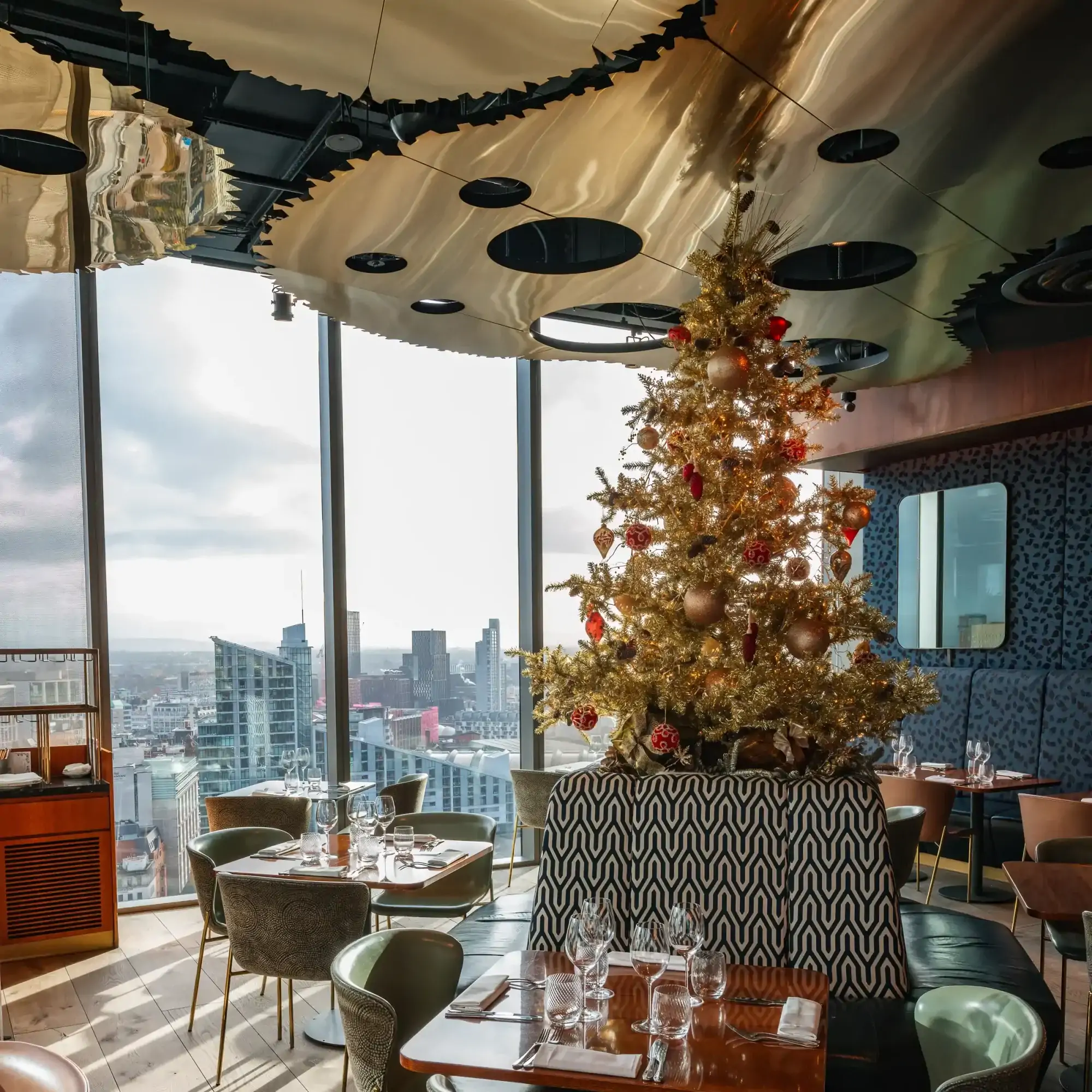 Interior of 20 Stories Restaurant with picture windows showing views across Manchester.