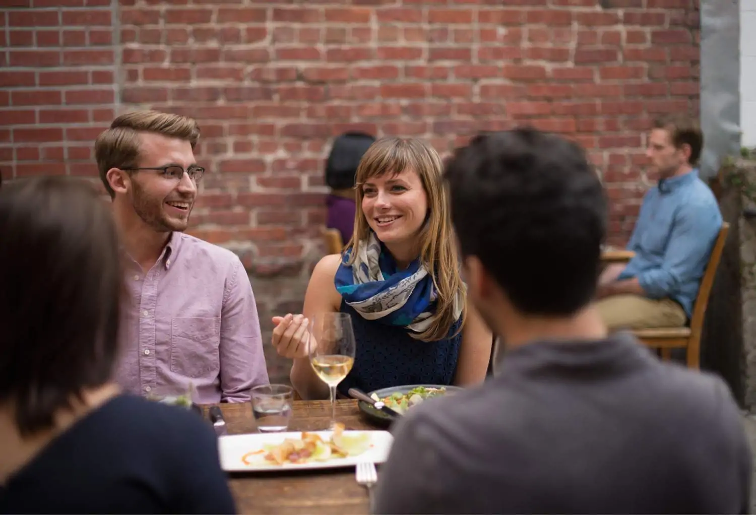 A group of diners seating in a restaurant and having a conversation