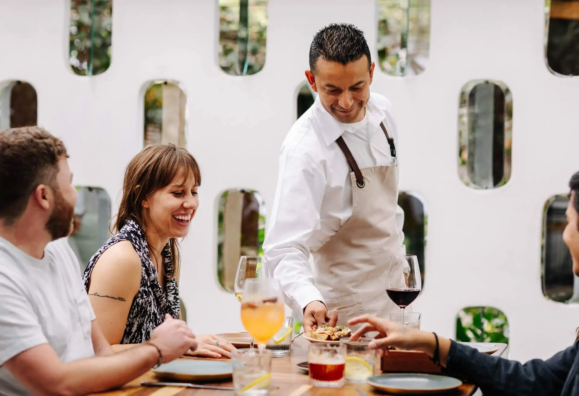 Waiter serving diners