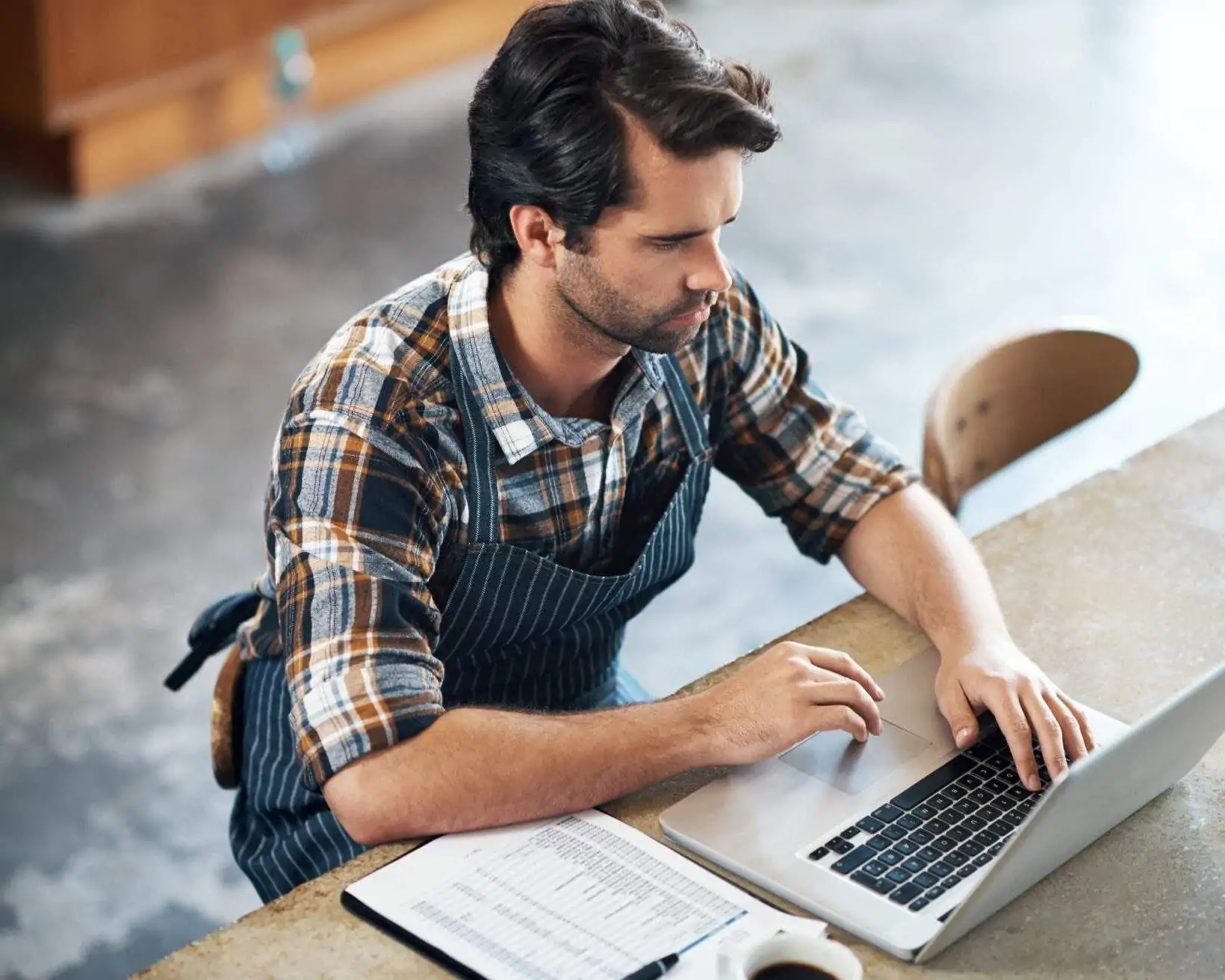 Restaurant employee working on his laptop