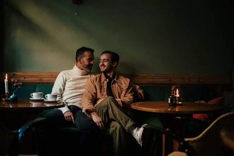 A couple looking at each other at a cafe