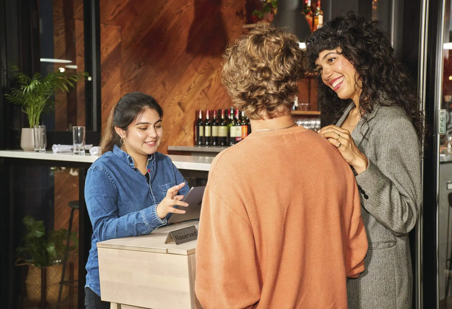 Hostess welcoming diners to a restaurant