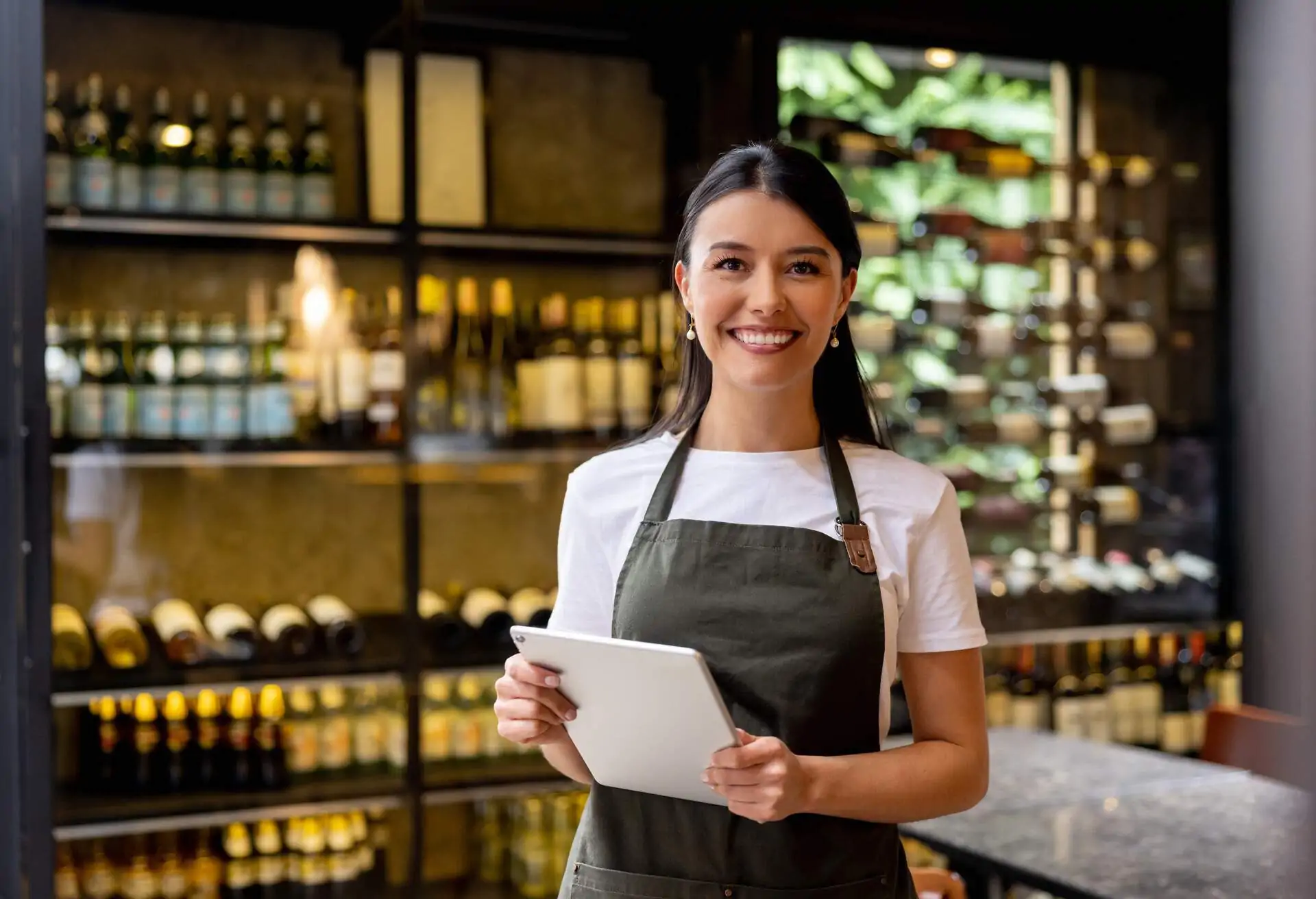 hostess at a restaurant holding an reservation system